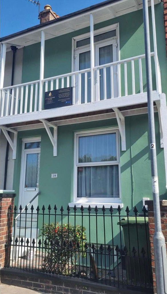 The same terrace after a full exterior repaint in sage green