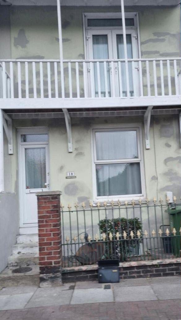 Tired, patchy rendered terrace before repainting